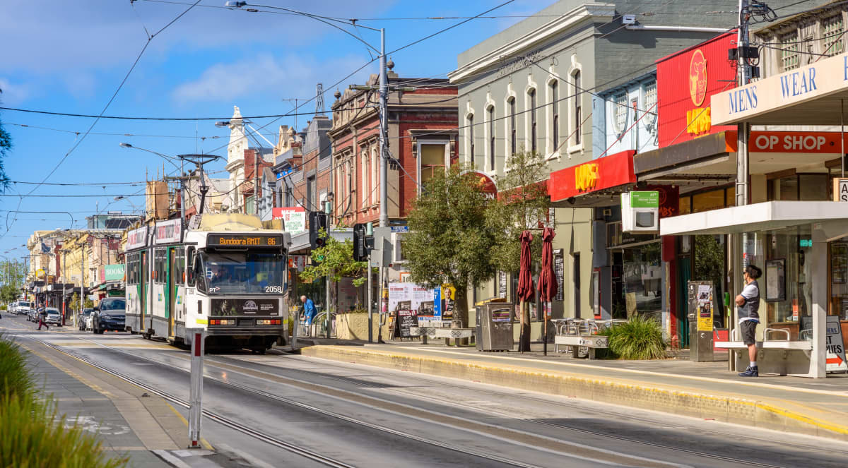 Northcote Australia November 9 2016: A unidentified man waits for the Number 86 tram on High Street in Northcote, Melbourne